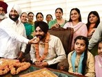 Mayor Sarabjeet Singh Samana with his father Kulwant Singh (in white turban) and other family members after assuming office in Mohali on Tuesday (SANJEEV SHARMA/HT)