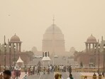 People seen out during a sudden dust storm over Kartavya path in New Delhi on Tuesday. (Sanchit Khanna/ HT Photo)