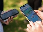 People play the Pokemon GO game on smartphones during the in-person Pokemon GO Tour. (Representational)