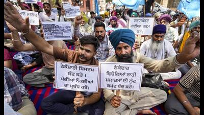 Members of Punjab Roadways, PUNBUS and PRTC Contract Workers Union, stage a protest demanding cancellation of the private kilometre scheme being implemented in the transport department, regularisation of contractual employees and immediate release of workers allegedly jailed during the course of the agitation, in Amritsar on Wednesday. (PTI)