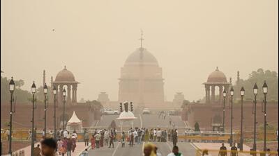 People seen out during a sudden dust storm over Kartavya path in New Delhi on Tuesday. (Sanchit Khanna/ HT Photo) People seen out during a sudden dust storm over Kartavya path in New Delhi on Tuesday. (Sanchit Khanna/ HT Photo)