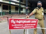 A security guard installs a warning board outside Nipah isolation ward at Government Medical College Hospital, in Kozhikode district in Kerala on Thursday. (PTI)
