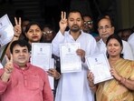 Bihar health minister Nishant Kumar and JD(U) leader Nishant Kumar, centre, party leaders Bharti Mehta, right, and Shivrani Devi Prajapati, left back, show their certificates of election after they were elected as Members of the Legislative Council (MLCs) in Patna on Thursday. (PTI)