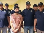 Haryana STF officials escort gangster Vainket Garg after his extradition from Georgia, in an operation coordinated by the CBI, in Gurugram on Thursday. (PTI)