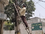 PCPCL worker repairing the line at Dugri area after thunderstorm that hit in Ludhiana. (Gurpreet Singh/HT)