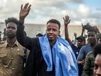 Somali referee Omar Artan waves to supporters after returning to Mogadishu following his denial of entry into the US ahead of the FIFA World Cup. (AFP)