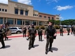 Law enforcement officials stand in front of the Collin County courthouse after the verdict was reached in the Karmelo Anthony trial, June 9, 2026, in McKinney, Texas. 