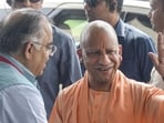 UP chief minister Yogi Adityanath, right, being received by BJP leader Tarun Chugh, on his arrival before a meeting of the ruling National Democratic Alliance (NDA) leaders in New Delhi on Wednesday. (PTI PHOTO)