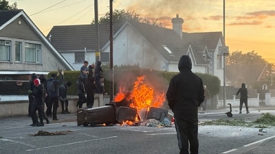 A fire burns in bins as anti-immigrant protesters clash with police. (REUTERS)