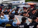 Police salute during a procession with the body of Toronto Police Const. Marc Pinizzotto, who was killed in the line of duty, at the Chief Coroner's office in Toronto, on Thursday. (AP)