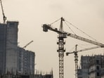 Tower cranes operate in a residential building construction site at the Jaypee Wish Town Project, developed by Jaypee Infratech Ltd., in Noida, Uttar Pradesh, India, on Thursday, Sept. 7, 2017. Fifteen miles east of India’s capital lies Jaypee Wish Town, a sprawling 1,162-acre site spotted with unfinished residential towers that embody the human cost of the nation’s bad-loan mess and point to the difficulty of resolving it. Photographer: Prashanth Vishwanathan/Bloomberg (Bloomberg)