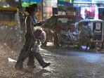 Women caught off guard by showers in Sector 22, Chandigarh, late on Thursday evening. (Keshav Singh/HT)
