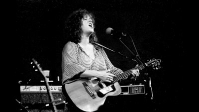 McIlwaine (1945-2021) performs in Chicago in 1980. Leave the slide guitar to the men, she was told. Instead, she played with a ferocity that was, at least for a while, impossible to ignore. She died five years ago this June. (Getty Images)