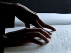 A visually impaired person reads using the Braille system (AFP Photo/Noah Seelam)