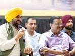 Punjab chief minister Bhagwant Mann with Aam Aadmi Party national convener Arvind Kejriwal during the state-level meeting of the Punjab State Traders Commission in Jalandhar on Saturday. (@BhagwantMann X)