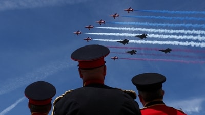 Members of the British military in ceremonial uniforms watch the Red Arrows perform a flypast from the Horse Guards Parade grounds, on the day of the Trooping the Colour parade, which honours Britain's King Charles, as part of the official birthday celebrations, in London, Britain, June 13, 2026. REUTERS/Toby Melville (REUTERS)