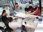 A CCTV grab showing assailants firing the shots at the cashier at Shri Kumar Medical Hall 1; and (right) police at the crime scene in Sector 11, Chandigarh, on Saturday. (SOURCED)