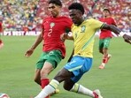 Achraf Hakimi of Morocco (left) competes for the ball against Vinicius Junior during their match against Brazil. (AFP)