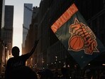 A fan waves a flag outside Madison Square Garden on the day of Game 5 of the NBA Finals between the New York Knicks and San Antonio Spurs, in New York City, US.