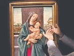 In the darkened hall, a solo pool of light gathered upon the Madonna and Child, isolating the frame in a halo of radiance.