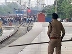 Police personnel chase aspirants of the Bihar Police Prohibition Department recruitment examination at the Pataliputra Railway Station in Patna on Sunday. (HT Photo)