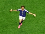 Japan's Koki Ogawa celebrates their second goal, scored by Daichi Kamada. 