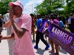 A person walks around announcing the guilty verdict in the Karmelo Anthony trial in front of the Collin County courthouse, Tuesday, June 9, 2026, in McKinney, Texas. (AP Photo/Tony Gutierrez)