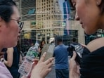 People monitoring stock prices on their phones as SpaceX shares began trading Friday.