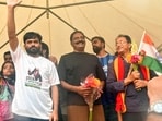 Founder of Cockroach Janata Party (CJP) Abhijeet Dipke, actor Prakash Raj, and environmentalist Sonam Wangchuk during the protest demanding the resignation of Union Education Minister Dharmendra Pradhan over NEET Exam paper leak and other alleged irregularities, at Freedom Park, in Bengaluru on Sunday. (ANI Photo)