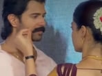 Vijay Deverakonda looks on as Rashmika Mandanna fixes his moustache.