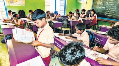 PUDUCHERRY, INDIA - DECEMBER Circa, 2018. Unidentified happy classmates in government school uniforms sitting, studying reading books indoors classroom. Portrait of school poor teenagers enjoying life (Shutterstock) PUDUCHERRY, INDIA - DECEMBER Circa, 2018. Unidentified happy classmates in government school uniforms sitting, studying reading books indoors classroom. Portrait of school poor teenagers enjoying life (Shutterstock)