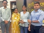 Deputy commissioner Himanshu Jain hands over the cheque to Harpreet Kaur in Ludhiana on Monday. (HT PHOTO)