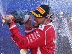 Ferrari's Lewis Hamilton celebrates after winning the Catalonia Grand Prix at the Circuit de Catalunya in Montmelo. (AFP)