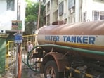 Pune, India - May 23, 2022: A water tank of a housing society is filled by the water tanker due to less pressure of the water at Karve Nagar, in Pune, India, on Monday, May 23, 2022. (Photo by Pratham Gokhale/Hindustan Times) (Pratham Gokhale/HT Photo)