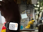 Bengaluru auto driver shows QR code on smartwatch to collect fare.