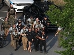 Sean Strickland, mixed martial artist, is escorted out of the UFC Freedom250 Fan Fest on The Ellipse by US Secret Service and other law enforcement officers ahead of the UFC Freedom250 fight on the South Lawn of the White House in Washington, DC, US, on Sunday, June 14, 2026. Photographer: Kevin Dietsch/Getty Images/Bloomberg