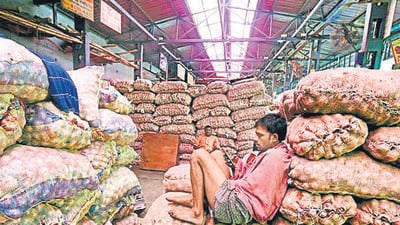 **EDS: WITH PTI STORY DEL3** New Delhi: A labourer rests on the onion sacks at Azadpur Mandi, a major market of the Agriculture Produce Marketing Committee (APMC), in New Delhi, Sunday, Sept. 22, 2019. Onion prices are spiralling reportedly due to shortage of supply and as per the data maintained by the consumer affairs ministry, retail onion prices rose to ₹57/kg in Delhi, ₹56/kg in Mumbai, ₹48/kg in Kolkata and ₹34/kg in Chennai last week. (PTI Photo/Shahbaz Khan) (PTI9_22_2019_000062A) *** Local Caption *** (PTI) **EDS: WITH PTI STORY DEL3** New Delhi: A labourer rests on the onion sacks at Azadpur Mandi, a major market of the Agriculture Produce Marketing Committee (APMC), in New Delhi, Sunday, Sept. 22, 2019. Onion prices are spiralling reportedly due to shortage of supply and as per the data maintained by the consumer affairs ministry, retail onion prices rose to ₹57/kg in Delhi, ₹56/kg in Mumbai, ₹48/kg in Kolkata and ₹34/kg in Chennai last week. (PTI Photo/Shahbaz Khan) (PTI9_22_2019_000062A) *** Local Caption *** (PTI)