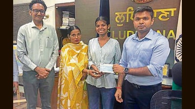 Deputy commissioner Himanshu Jain hands over the cheque to Harpreet Kaur in Ludhiana on Monday. (HT PHOTO) Deputy commissioner Himanshu Jain hands over the cheque to Harpreet Kaur in Ludhiana on Monday. (HT PHOTO)