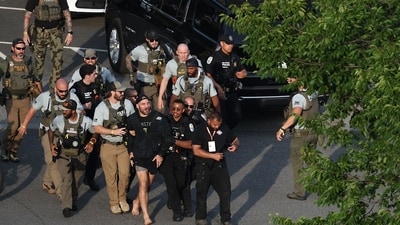 Sean Strickland, mixed martial artist, is escorted out of the UFC Freedom250 Fan Fest on The Ellipse by US Secret Service and other law enforcement officers ahead of the UFC Freedom250 fight on the South Lawn of the White House in Washington, DC, US, on Sunday, June 14, 2026. Photographer: Kevin Dietsch/Getty Images/Bloomberg (Bloomberg)