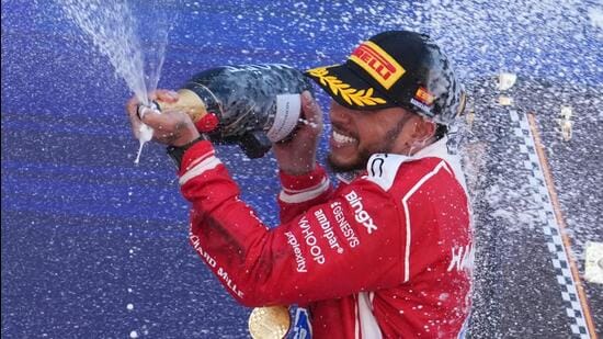 Ferrari's Lewis Hamilton celebrates after winning the Catalonia Grand Prix at the Circuit de Catalunya in Montmelo. (AFP)