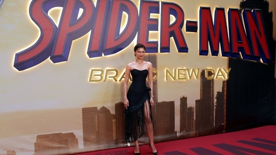 Zendaya looked stunning in a sleek black Christian Cowan cocktail dress featuring a sweetheart neckline and a sultry thigh-high slit. The standout detail, however, was the dress's fringed hem, which cascaded into intricate tassels, making a strong case for the revival of classic flapper-era cocktail accents in contemporary fashion.(AFP)