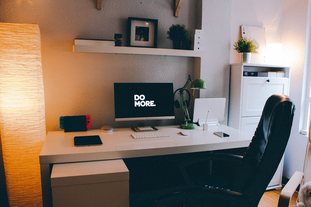 A small section carved out in a room that includes a small desk, chair, and lamps can help you keep work and personal life activities in their respective spheres. (Unsplash)