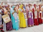 Chief minister Yogi Adityanath interacts with farmers who arrived in Lucknow by one of the inaugural flights from the Noida International Airport on Monday. (HT)