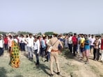 Cops and villagers near the crime scene in Nibi Kukurkatwa village of Prayagraj on Tuesday (HT Photo) Cops and villagers near the crime scene in Nibi Kukurkatwa village of Prayagraj on Tuesday (HT Photo)