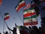 People wave pre-revolutionary Iranian flags during a protest outside Los Angeles Stadium before the World Cup between Iran and New Zealand on Monday, June 15. People wave pre-revolutionary Iranian flags during a protest outside Los Angeles Stadium before the World Cup between Iran and New Zealand on Monday, June 15.