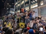 Fans climb a truck while celebrating after the New York Knicks defeated the San Antonio Spurs in Game 5 of the NBA Finals to win the title in New York, US, early on Sunday, June 14, 2026. Photographer: Victor J. Blue/Bloomberg