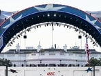 Security at the White House looks through a pair of binoculars during the UFC Fan Fest on the White House Ellipse ahead of Sunday's fight on the South Lawn, June 13, 2026, in Washington. 