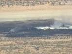Smoke rises from a blackened part of Edwards Air Force Base after the crash of a U.S. Air Force B-52 bomber aircraft in Edwards, California, US, in a still image from news helicopter video. 