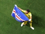 Vozinha #1 of Cabo Verde waves a flag in-front of the fans after the 0-0 draw vs Spain. 