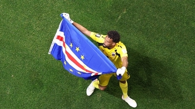Vozinha #1 of Cabo Verde waves a flag in-front of the fans after the 0-0 draw vs Spain. (Getty Images via AFP)
